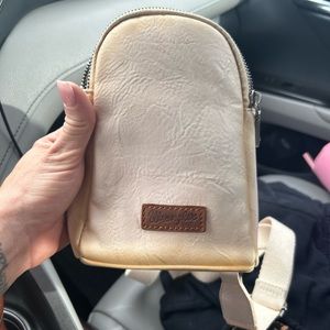Wrangler chest strap purse almost like the lululemon ones . Off white distressed